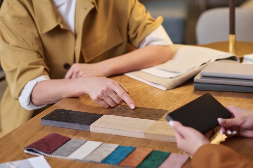 hand,of,young,female,client,pointing,at,sample,of,brown