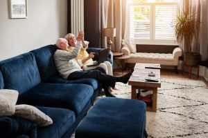 high,five,,laptop,and,retirement,with,a,senior,couple,on